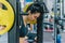 Muscular attractive young woman doing workout in the gym, lifting weights with barbell on shoulders. Hard workout for cross fit.