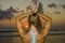 Muscular back of fit and healthy attractive woman practicing fitness and yoga in beautiful sunset beach in meditation and relaxati