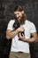 Muscular bearded man holding little dog