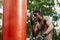 Muscular black professional boxer sweating in gloves boxing training outdoors, young african american boxer exercising