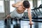 Muscular bodybuilder man doing push ups exercise with one hand in fitness gym . Shirtless young sport man training .work out