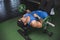 A muscular and buff asian man does a set of lying tricep extensions, also known as skull crushers. Working out Triceps and arms at