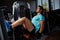 Muscular build man doing legs press exercise in fitness center