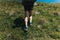 Muscular calves of a young athlete running with backpack up a mo