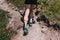 Muscular calves of a young athlete running up a mountain path, u