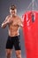 Muscular Fighter Prepare for Practicing Some Kicks with Punching Bag