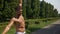 Muscular fit man in a park doing stretching exercises and sweating