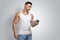 Muscular fitness male holding protein shake bottle