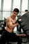 Muscular fitness man flipping tire wheel. Concept functional training workout gym