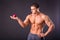 Muscular guy holding apple and pear