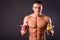 Muscular guy holding apple and pear