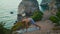 Muscular guy training yoga asana stretching at beautiful ocean cliff edge alone.