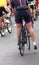muscular legs of woman cyclist after the bicycle race in the cit