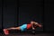 Muscular male adult exercising with kettle bells