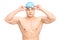 Muscular male swimmer putting on his swim goggles