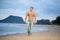 Muscular male walking along a beach