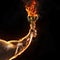 Muscular man arm holding burning trophy cup on black background