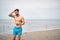 Muscular man on the beach..Handsome  man having fun on the beach by the sea and listen music