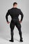 Muscular man in black compression sportswear rear view on gray background