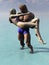 Muscular man carries woman from water