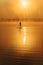 Muscular man on distance paddling on sup board