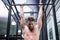 Muscular man doing pull ups