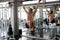 Muscular man doing pulling up on bar and pumping up  six pack abdominal at gym  .workout , exercises , bodybuilder training ,