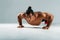 Muscular man doing push up exercises in studio