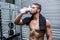 Muscular man drinking protein cocktail