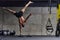 A muscular man in a handstand position, showcasing his exceptional balance and body control while performing a variety