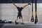 A muscular man in a handstand position, showcasing his exceptional balance and body control while performing a variety