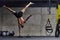 A muscular man in a handstand position, showcasing his exceptional balance and body control while performing a variety