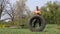 Muscular man hitting standing tire with a hammer