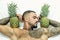 Muscular man hold pineapple fruit on biceps. brutal sportsman relax in bed. steroids. sexy ab of tattoo man diet. male