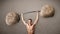 Muscular man lifting large rock stone weights