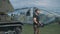 Muscular man in a military uniform has arranged training at a military base.