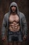 Muscular man with open jacket revealing muscular chest and abs