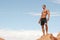 Muscular man on red rocks