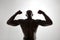 Muscular man\'s back in silhouette