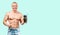 Muscular man taking protein sports nutrition on green background