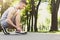 Muscular man tying shoelaces before running