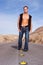 muscular man walking on desert road