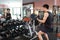 Muscular man working out in gym doing exercises with dumbbells at biceps, strong male naked torso abs