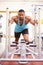 Muscular man working out using equipment at a gym, vertical