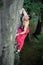 Muscular rock climber climbs on overhanging cliff