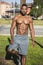 Muscular Shirtless Black Man in Park