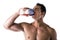 Muscular shirtless male bodybuilder drinking protein shake from blender