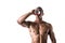 Muscular shirtless male bodybuilder drinking protein shake from blender