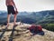 Muscular shirtless man have lunch in high rocks