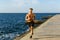 muscular shirtless sportsman jogging